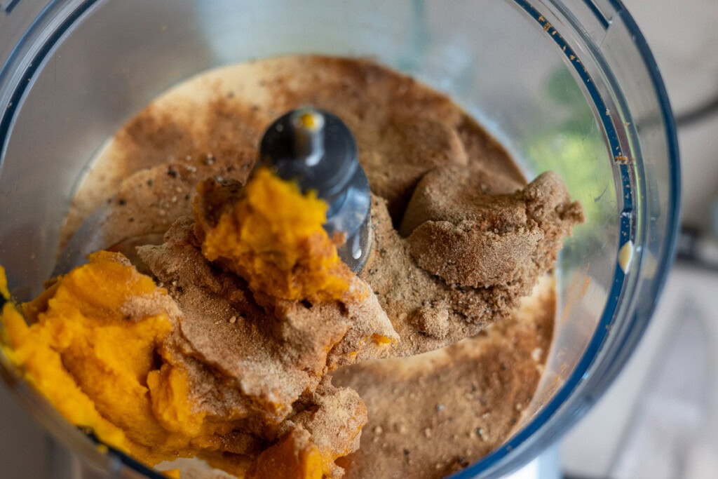 smoked pumpkin pie filling in the bowl of a food processor