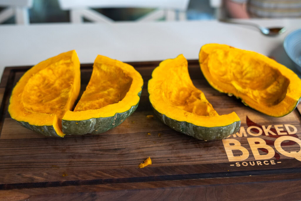 raw seedless pumpkin cut into quarters