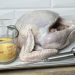 turkey injection liquid next to raw turkey and injector
