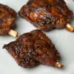 buffalo garlic pig wings on a white plate