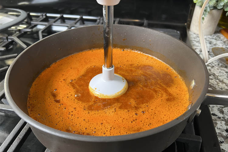 blender immersed into blended sauce