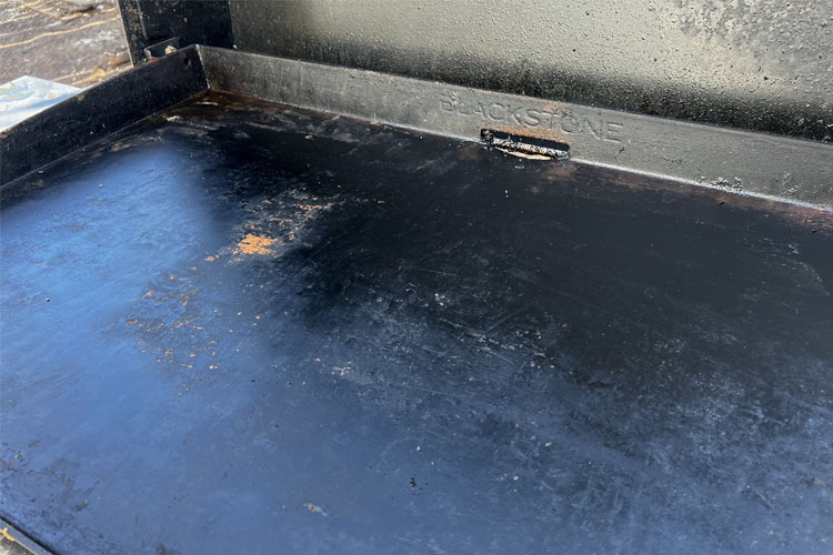old food stuck on a griddle