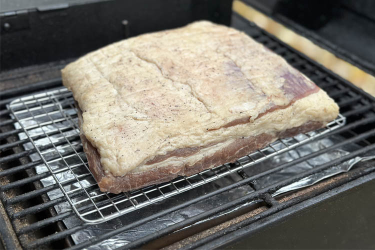 raw beef bacon in the grill