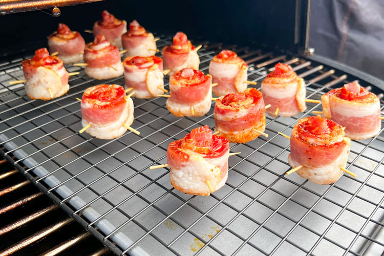 rack of uncooked bacon roses in the smoker