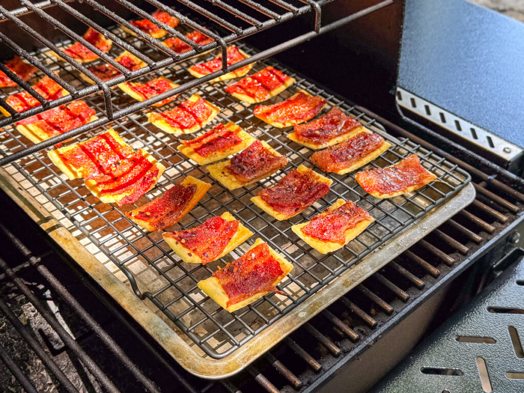 crispy bacon topped crackers in the smoker