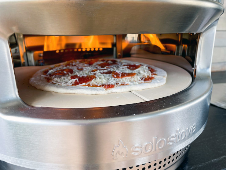uncooked pizza in the Solo Stove Pi pizza oven