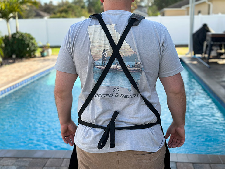 a man wearing a crossback design bbq apron