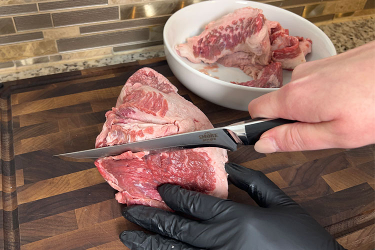 chopping up raw brisket