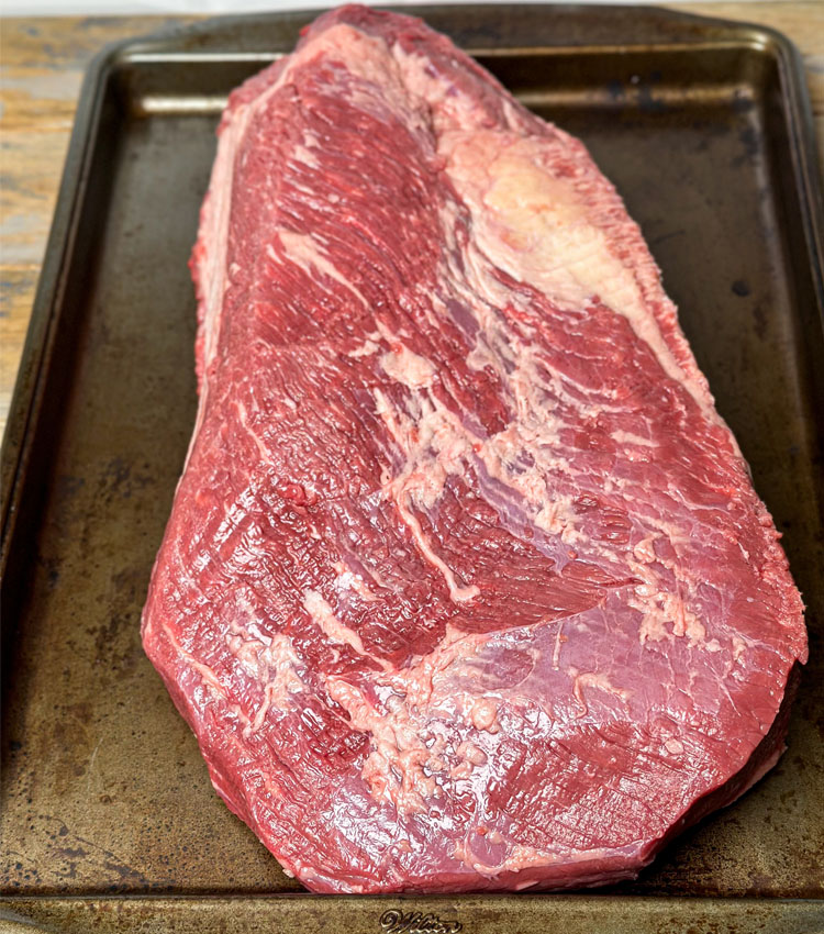 trimmed brisket in a metal baking dish