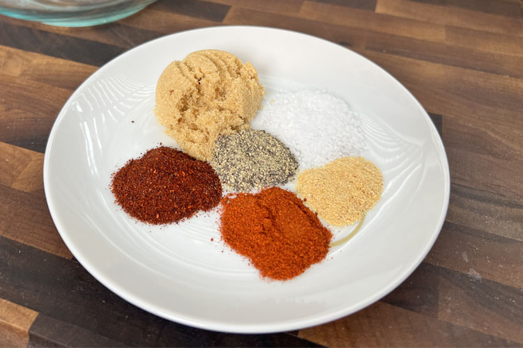 a white plate with individual piles of seasoning