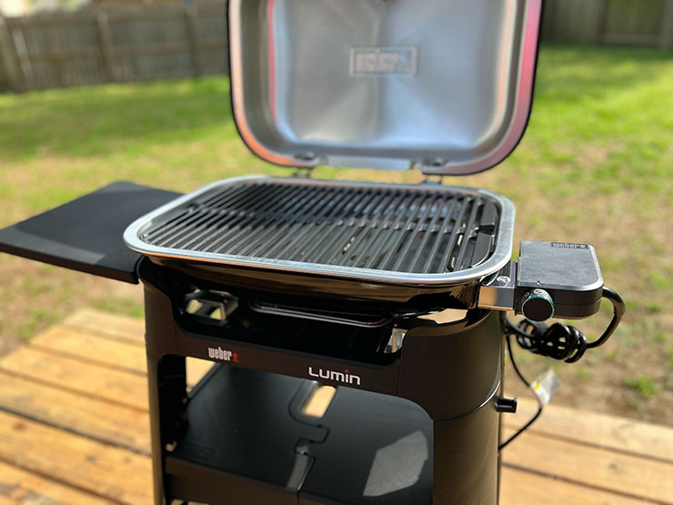 a side view of the Weber Lumin grill with an open lid