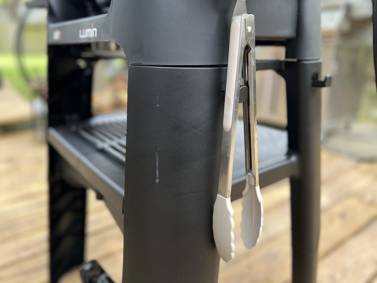 grill tongs hang on a tool holder on Weber Lumin