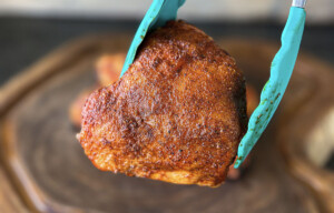 chicken thigh with crispy skin smoked on a pellet smoker