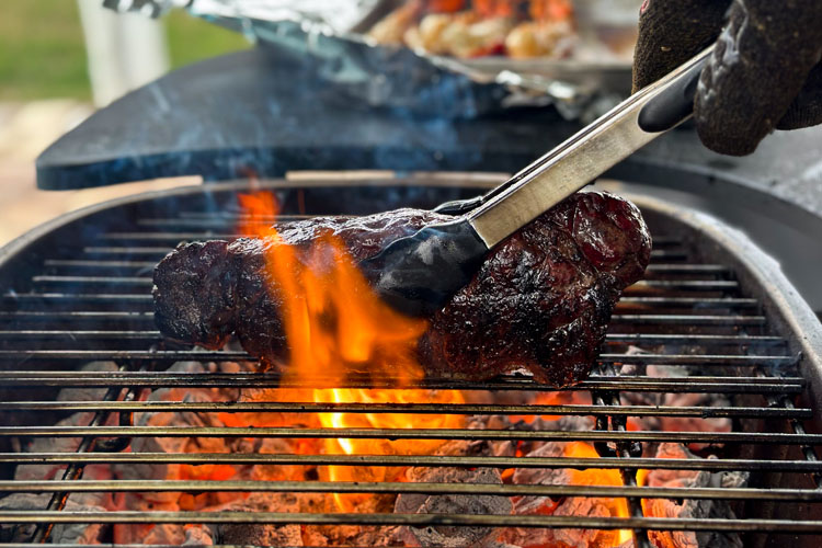 searing steak with flames 