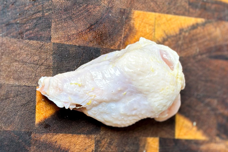 drumette on a wooden chopping board