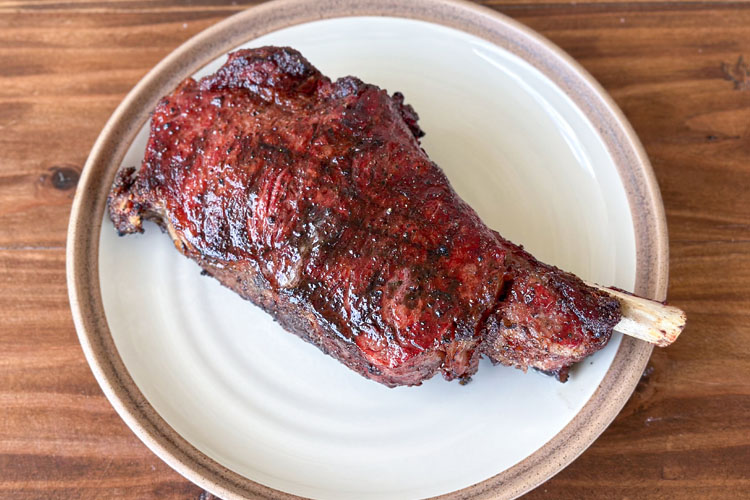 cooked delmonico steak on a white plate