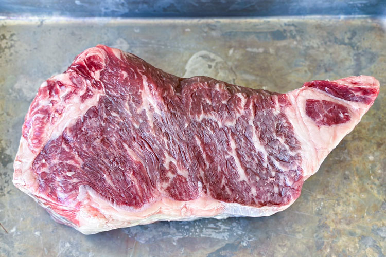 looking down on raw a delmonico steak