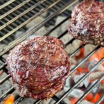 grilled ribeye cap steaks on a charcoal grill