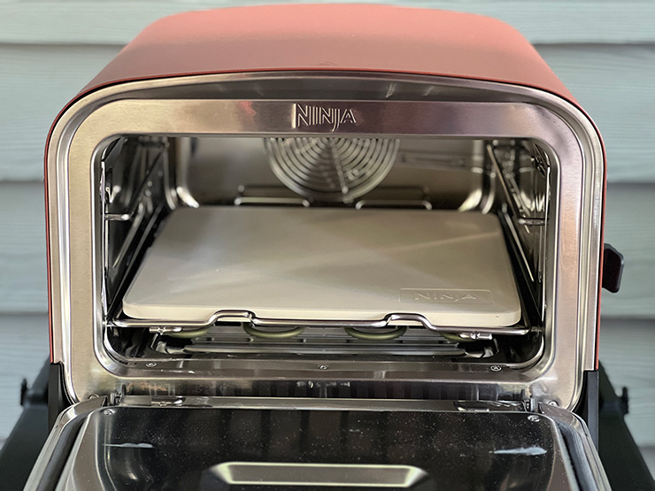 a front view of the Ninja Woodfire Outdoor Oven with an open door