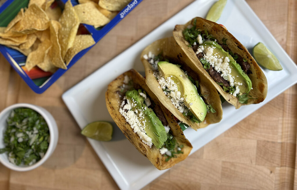 smashburger tacos on platter with corn chips