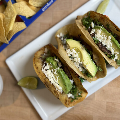 smashburger tacos on platter with corn chips