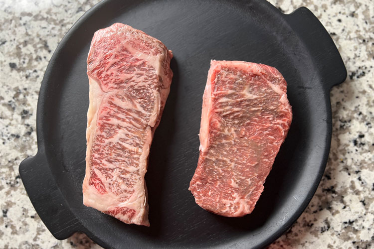 japanese wagyu and american wagyu on a black plate