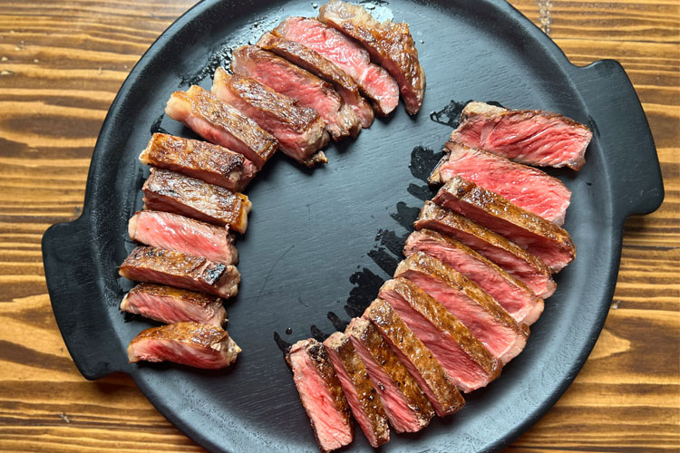 wagyu sliced on a black plate