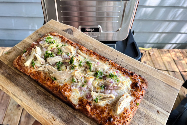 BBQ chicken pizza cooked in front of ninja outdoor oven