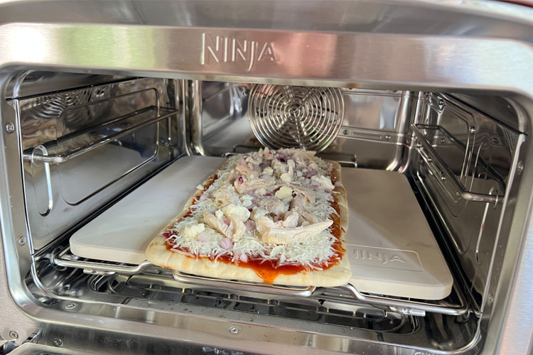 uncooked pizza in ninja woodfire oven