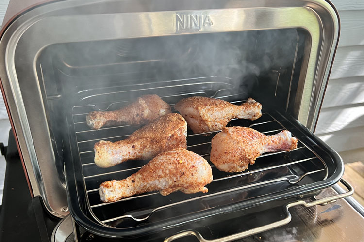 raw seasoned drums on the ninja woodfire outdoor oven