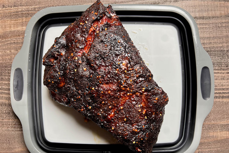 cooked pulled pork butt on a white board