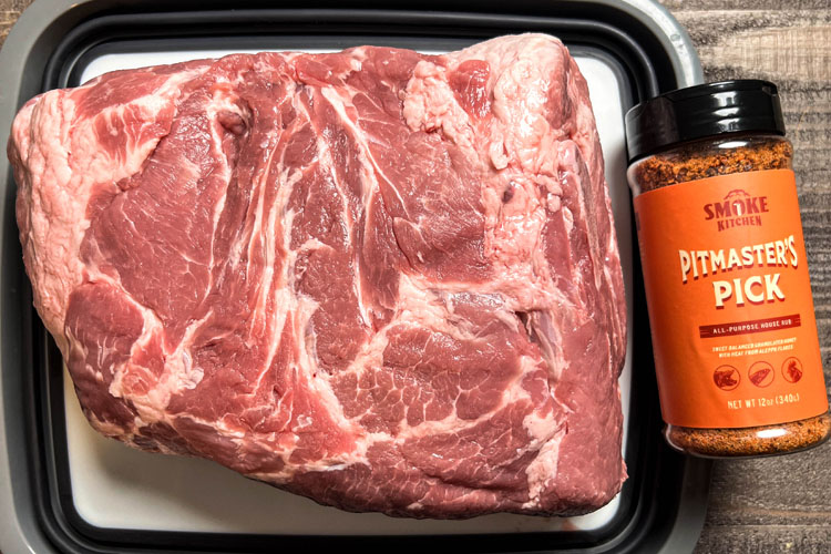 raw pork butt with smoke kitchen pitmaster rub bottle