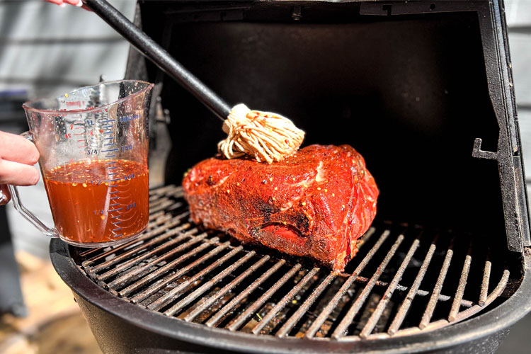 pork butt being mopped