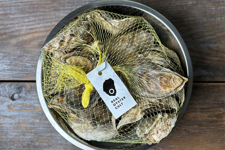 a bag of oysters in a tin bowl