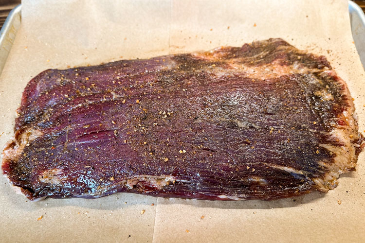 raw flank steak with bbq rub
