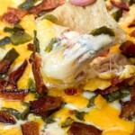 a nacho dip covered with smoked jalapeƱo popper dip