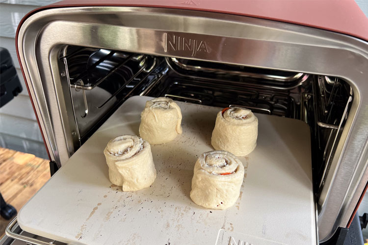 uncooked pepperoni pizza rolls in ninja woodfire oven