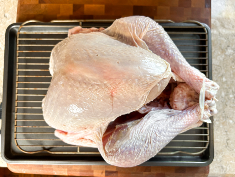 raw turkey on a wire rack