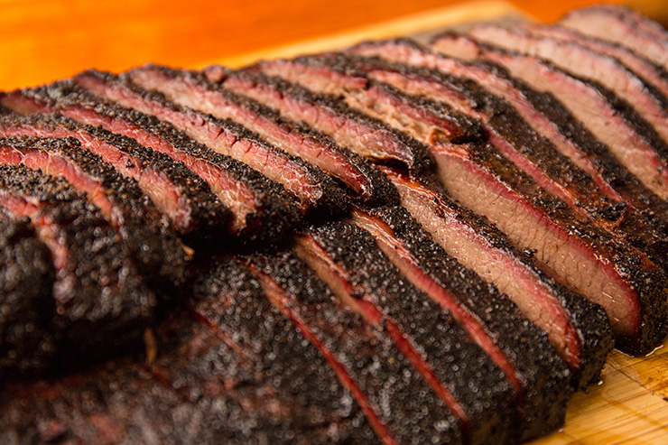 sliced brisket served on a wooden board