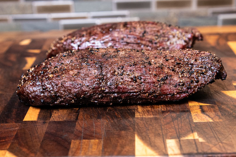 teres major steak resting on a wooden board