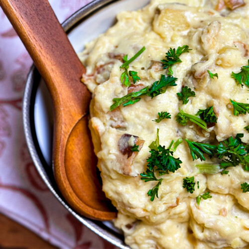 smoked garlic mashed potatoes plated with a wooden serving spoon