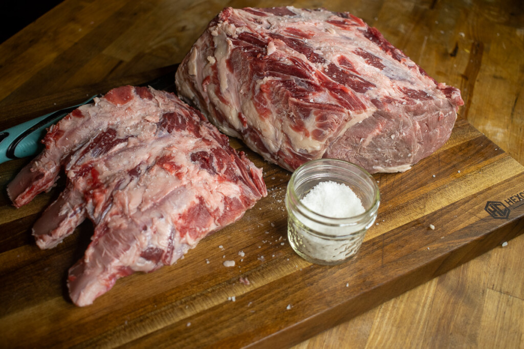 bone removed from raw prime rib and a dish of salt