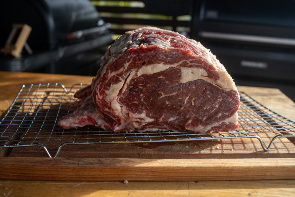 a raw pice of prime rib on a wire rack