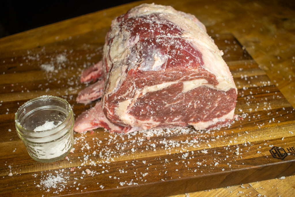 a raw pice of prime rib with salt sprinkled all over it