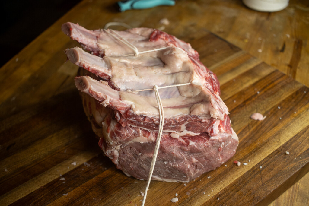 a raw prime rib with butcher string tied around it