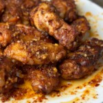 chili oil chicken wings on a white plate