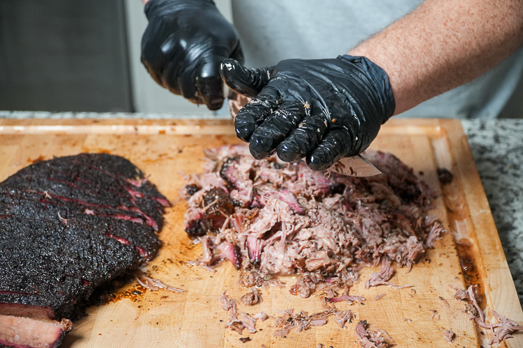 chopped up brisket on a wooden board