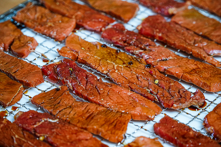 prepped peppered beef jerky on dehydrator rack 