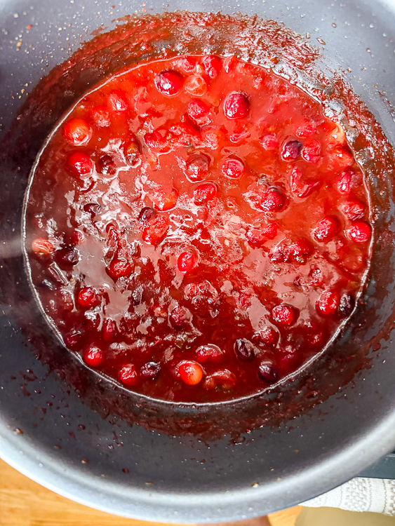 pot of cranberries nearly cooked on smoker
