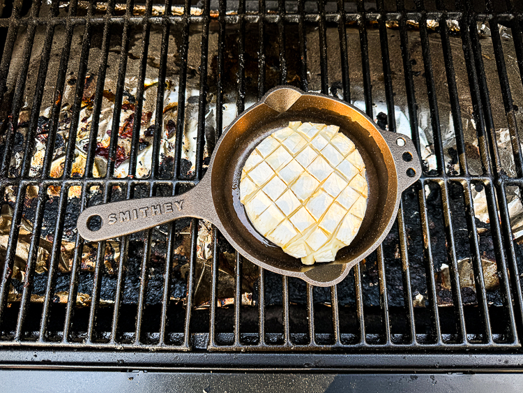 wheel of brie melting in smoker